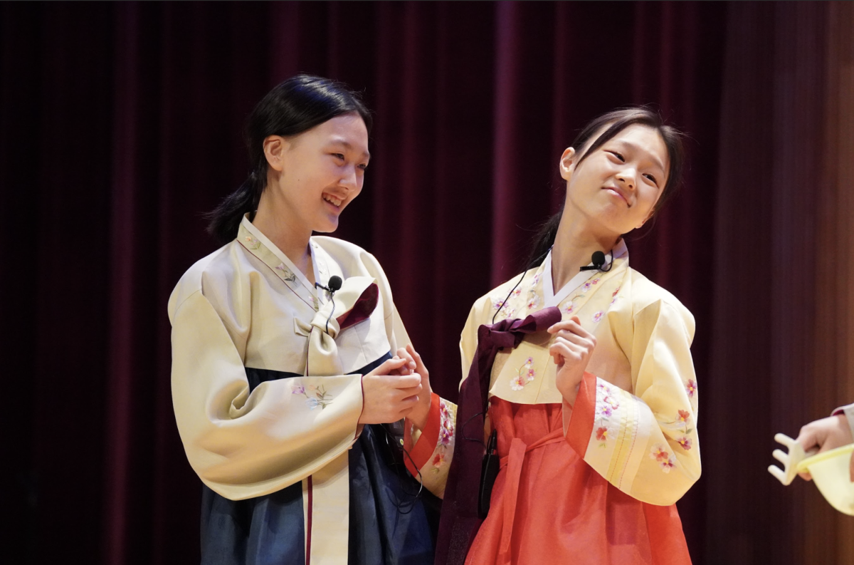 Eighth-graders Jules Youn and Stella Lee preen as they prepare for the ball. Youn, playing 팥쥐 (Patjwi), and Lee, as the stepmother, pour their hearts into making 콩쥐 (Kongjwi)’s life as difficult as possible. 